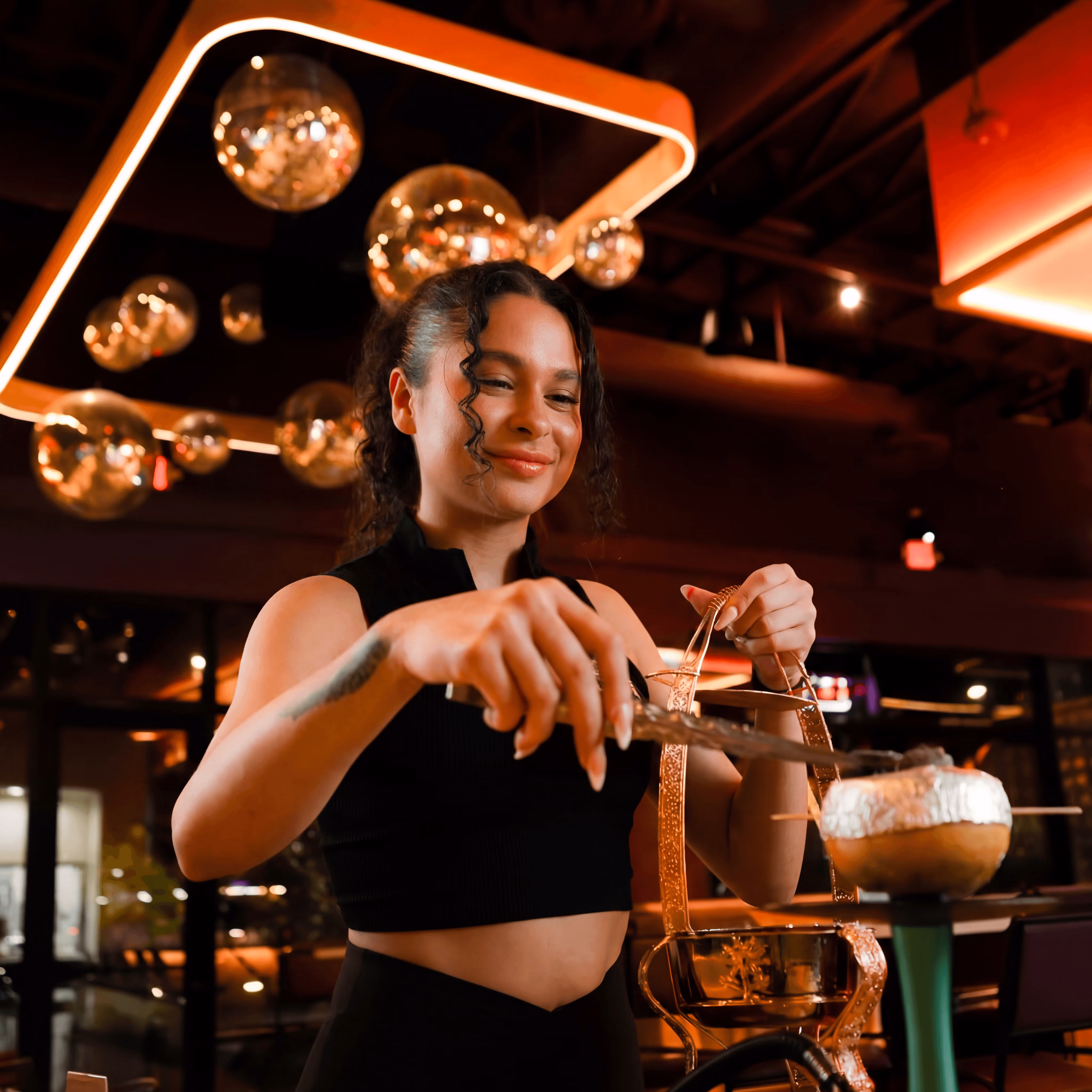 Guest preparing a premium citrus hookah at Citrus Grill & Lounge